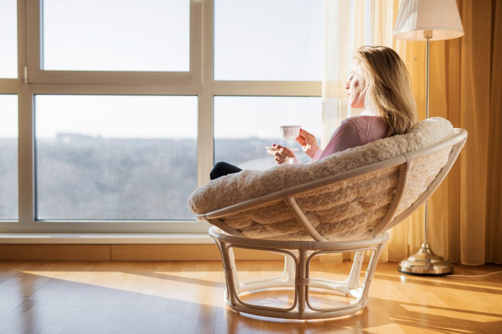 Woman sitting in chair and drinking tea